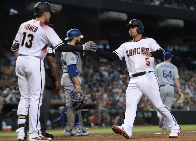 Los Angeles Dodgers pitcher Caleb Ferguson and catcher Russell Martin react to the Arizona Diamondbacks scoring