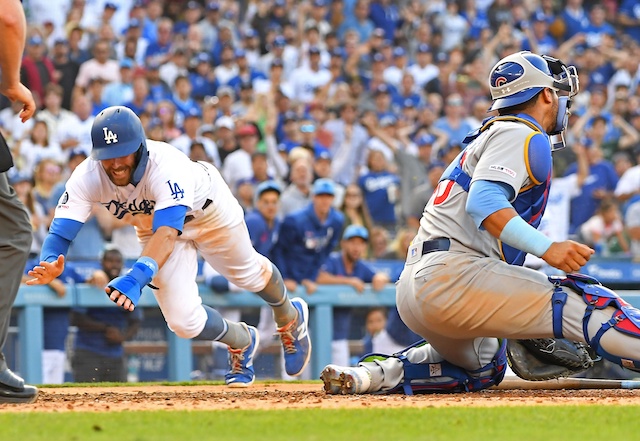 Los Angeles Dodgers shortstop Chris Taylor dives into home plate against the Chicago Cubs