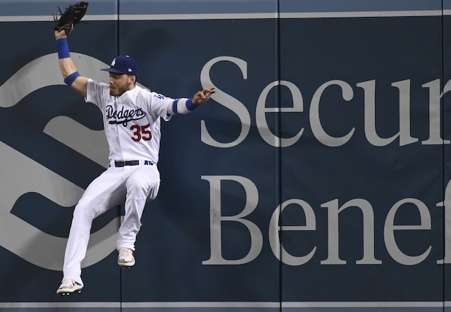 Los Angeles Dodgers right fielder Cody Bellinger makes a leaping catch at the wall