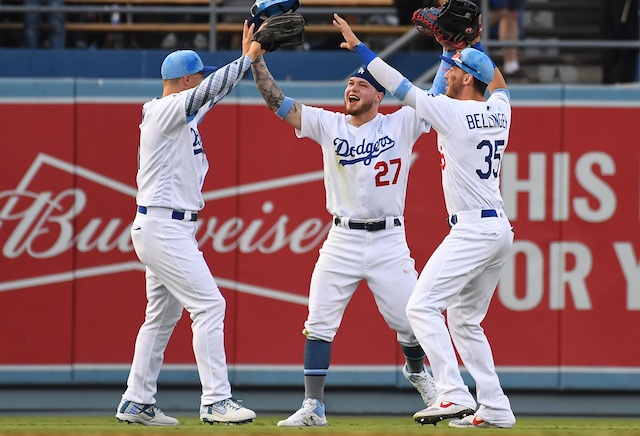 Cody Bellinger, JocPederson and Alex Verdug celebrate after the Los Angeles Dodgers defeat the Chicago Cubs