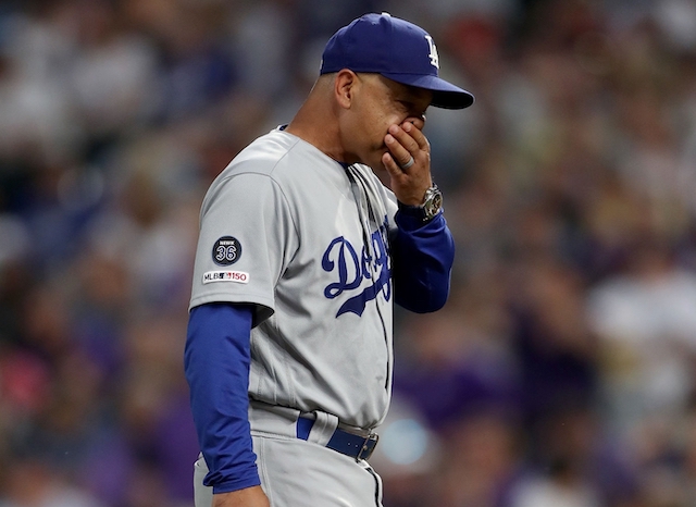 Los Angeles Dodgers manager Dave Roberts walks back to the dugout at Coors Field