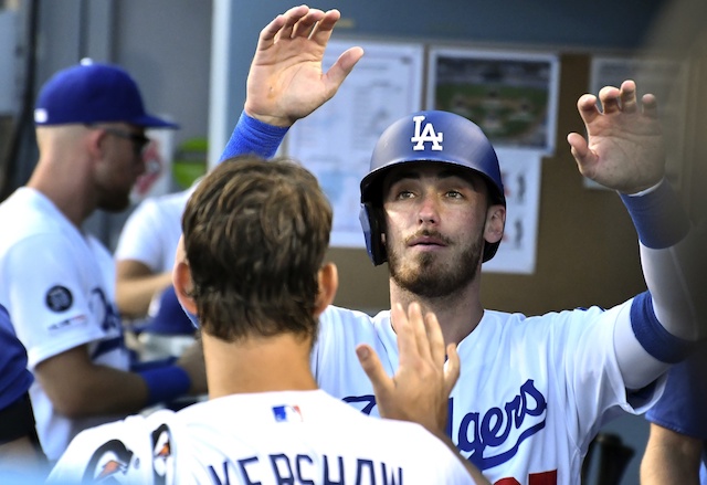 Cody Bellinger is congratulated by Clayton Kershaw in the Los Angeles Dodgers dugout