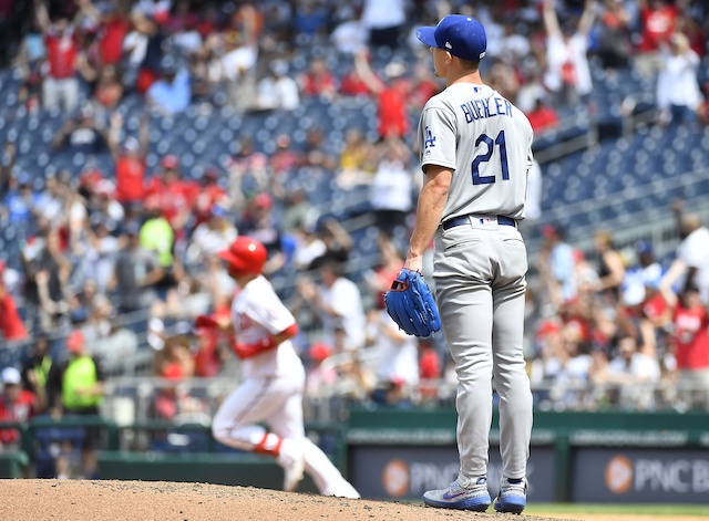 Los Angeles Dodgers pitcher Walker Buehler reacts after allowing a home run to Washington Nationals second baseman Brian Dozier