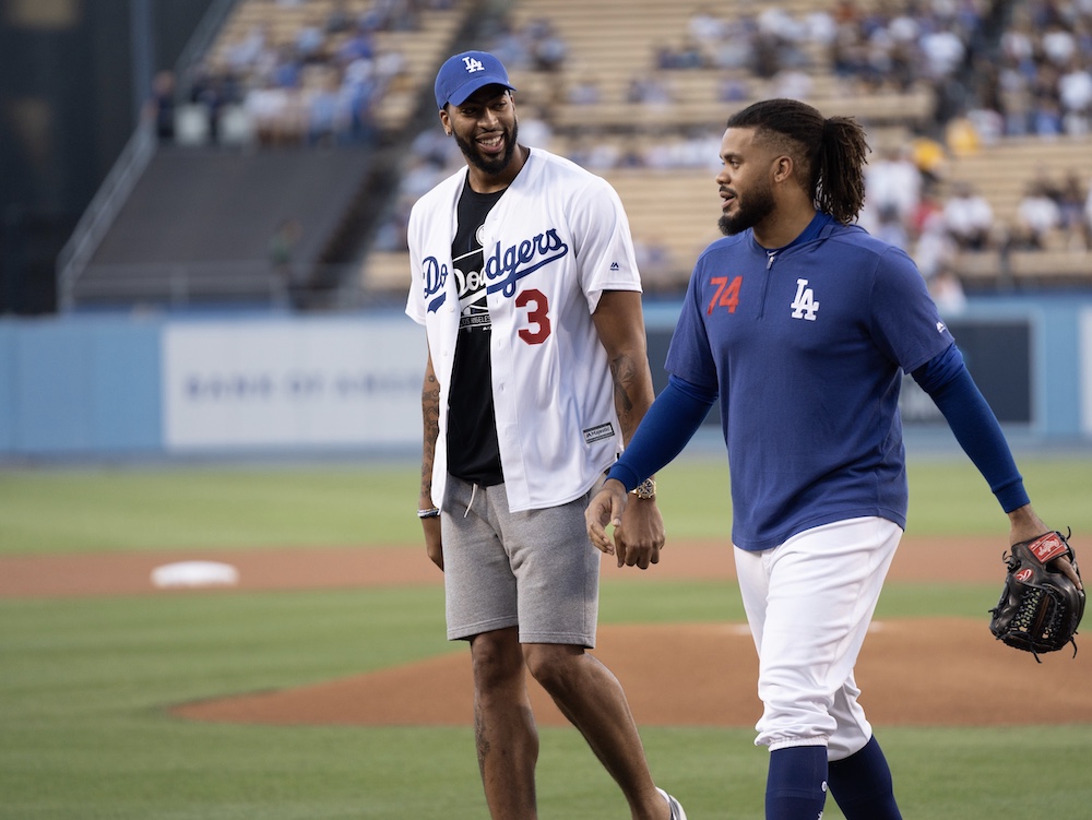 Los Angeles Dodgers closer Kenley Jansen walks off the field with Anthony Davis after he threw out the first pitch on Lakers Night at Dodger Stadium