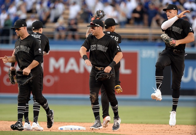 Brett Gardner, Aaron Judge and the New York Yankees celebrate after a win against the Los Angeles Dodgers