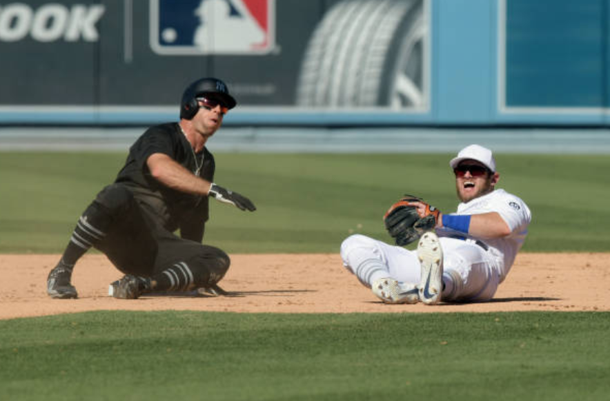 New York Yankees center fielder Brett Gardner slides into Los Angeles Dodgers infielder Max Muncy