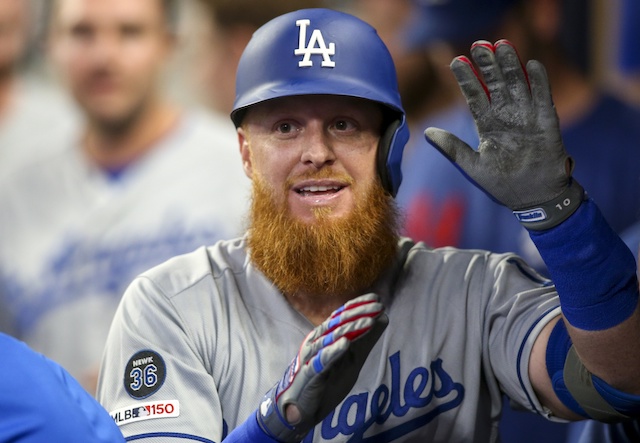 Los Angeles Dodgers third baseman Justin Turner is congratulated in the dugout after hitting a home run