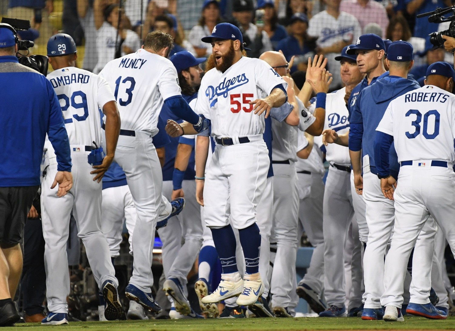 Matt Beaty, Bob Geren, George Lombard, Russell Martin, Max Muncy and Dave Roberts celebrate after a Los Angeles Dodgers walk-off win