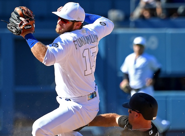 New York Yankees center fielder Brett Gardner slides into Los Angeles Dodgers second baseman Max Muncy