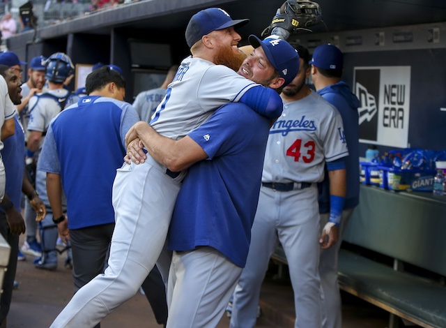 Los Angeles Dodgers teammates Rich Hill and Justin Turner embrace before a game at SunTrust Park