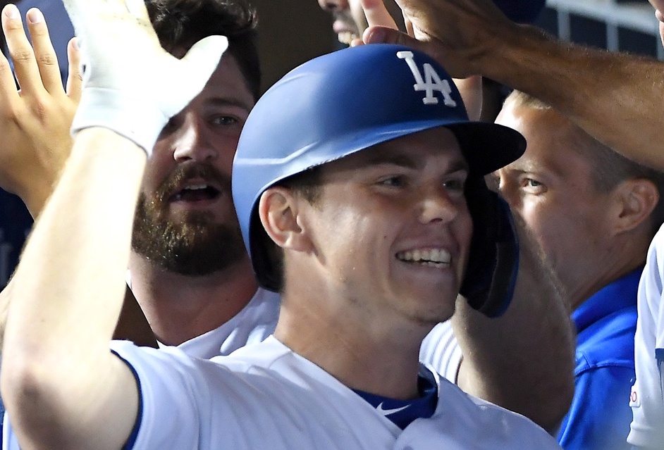 Will Smith is congratulated in the Los Angeles Dodgers dugout after hitting a grand slam against the San Diego Padres