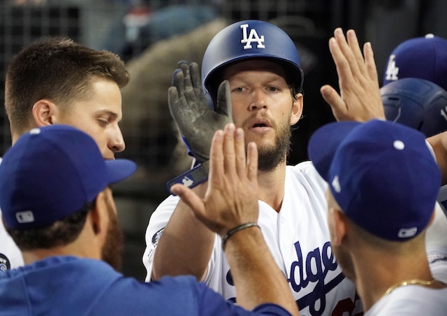 Los Angeles Dodgers pitcher Clayton Kershaw is congratulated in the dugout