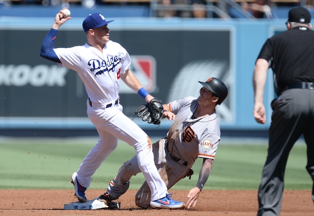 Los Angeles Dodgers infielder Gavin Lux infielder throws the ball to first base