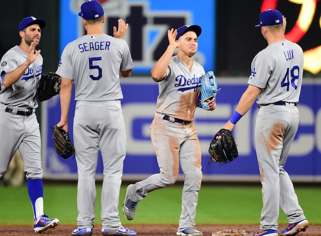 Los Angeles Dodgers teammates Kiké Hernandez, Gavin Lux, Corey Seager and Chris Taylor celebrate after a win