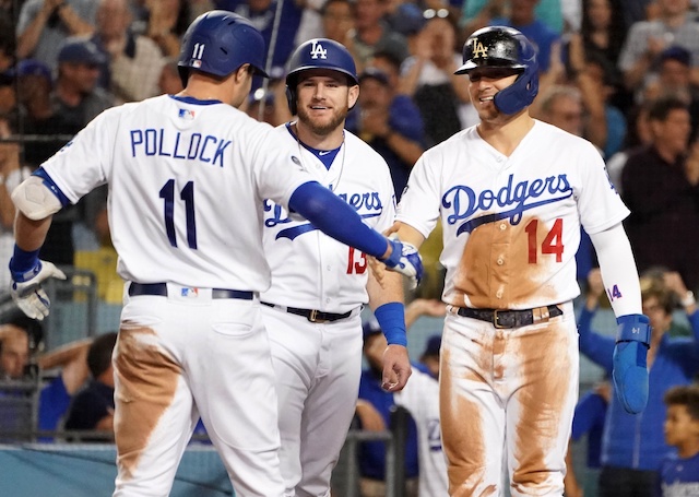 Los Angeles Dodgers teammates Kiké Hernandez, Max Muncy and A.J. Pollock celebrate after a home run