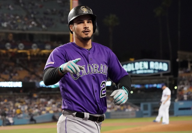 Colorado Rockies third baseman Nolan Arenado celebrates after hitting a home run against Los Angeles Dodgers pitcher Clayton Kershaw