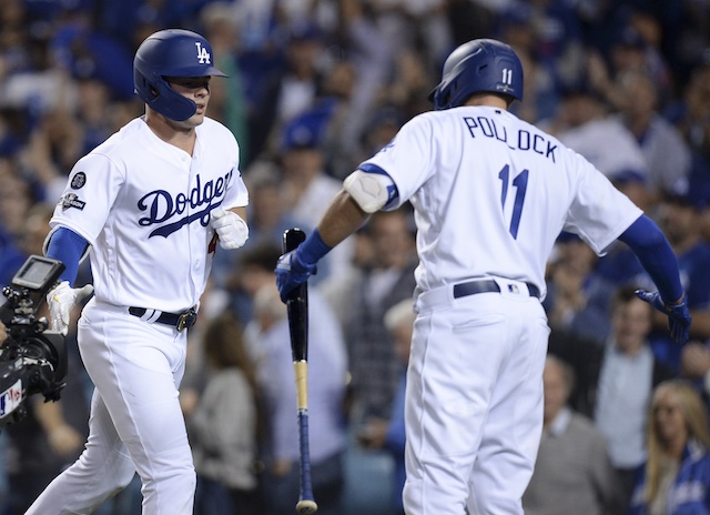 Los Angeles Dodgers teammates Gavin Lux and A.J. Pollock celebrate during Game 1 of the 2019 NLDS