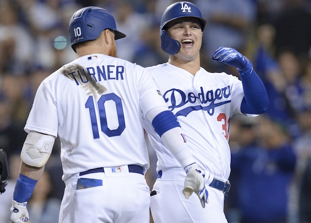 Los Angeles Dodgers teammates Joc Pederson and Justin Turner celebrate after a home run in Game 1 of the 2019 NLDS